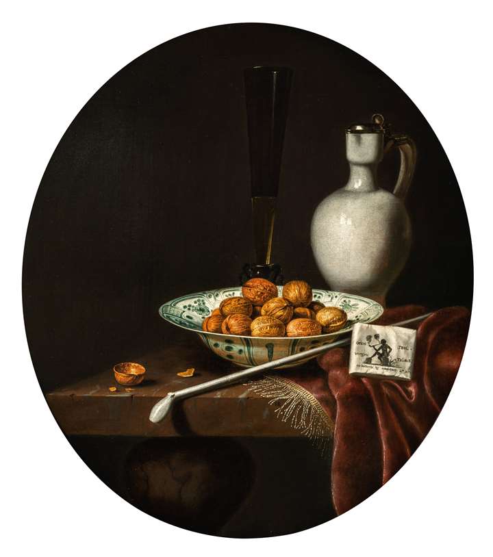 Still Life of Walnuts in a Wan-Li Porcelain Bowl, a glazed Earthenware Jug, and a Pipe and Smoking Materials on a partly draped Table. 
